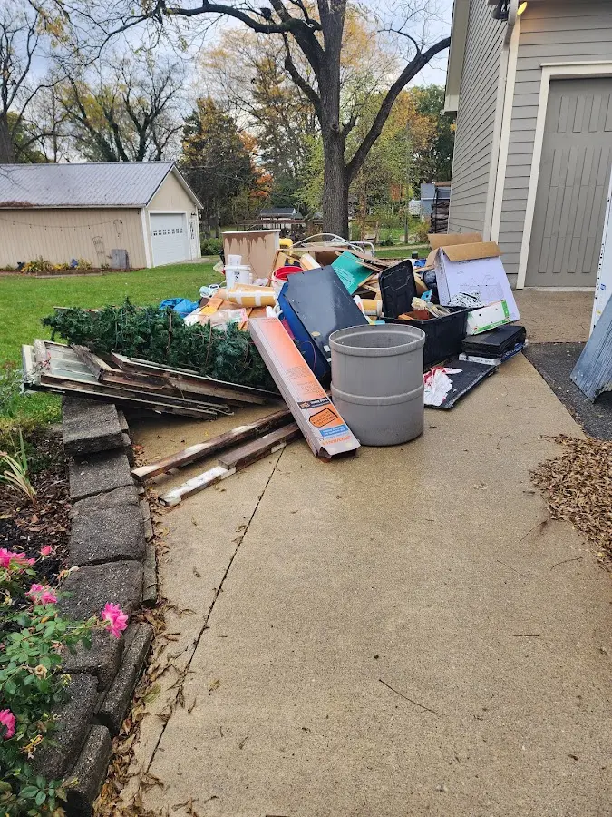 Dumpster being loaded with debris for Estate Cleanout Dumpster Rental in Bargersville